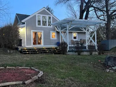 a white house with a pergola on a yard at Country House in Catskills in Saugerties