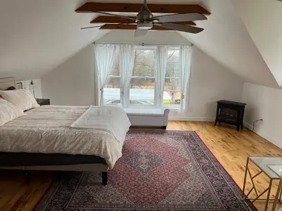 a bedroom with a bed and a ceiling fan at Country House in Catskills in Saugerties