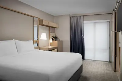 a hotel room with a bed and a window at SpringHill Suites by Marriott New York Manhattan Times Square in New York