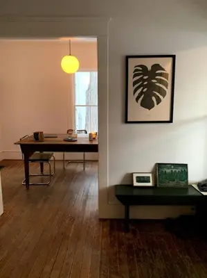 a living room with a table and a window at Bovina House in Bovina Center