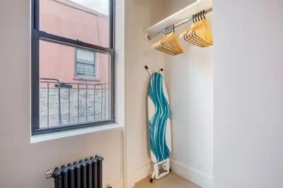 a room with a window and a shower curtain at Blueground Chelsea elev wd nr 8th Ave NYC-1450 in New York