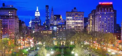 a view of a city at night with lights at Oasis Apartment in the Heart of Union Square Downtown Manhattan in New York