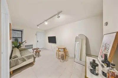 a living room with a couch and a table at Oasis Apartment in the Heart of Union Square Downtown Manhattan in New York