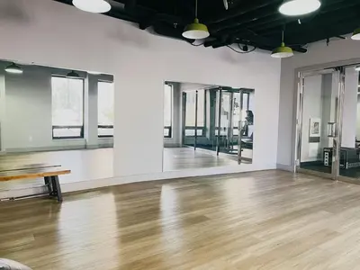 an empty room with a wooden floor and windows at Modern Condo DWNTN Hartord XL Center GYM in Hartford