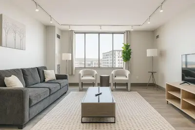 a living room with a couch and a tv at Modern Condo DWNTN Hartord XL Center GYM in Hartford