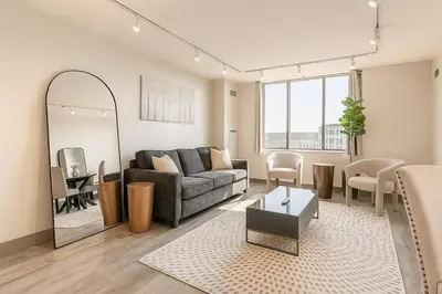 a living room with a couch and a table at Modern Condo DWNTN Hartord XL Center GYM in Hartford