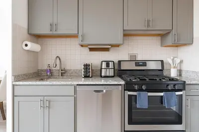 a kitchen with a stove and a sink at Downtown Hartford Condo - Bushnell Park - Convention Center in Hartford