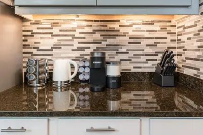 a kitchen counter with a coffee maker on a counter top at Downtown Hartford Condo - Bushnell Park - Convention Center in Hartford