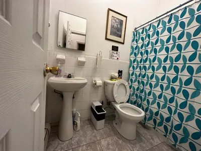 a bathroom with a toilet and a sink at Townhouse in Uptown Manhattan in New York