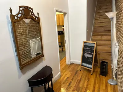 a stairway with a mirror and a chair in a room at Townhouse in Uptown Manhattan in New York