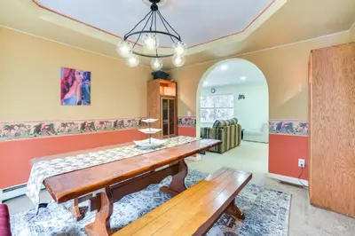 a dining room with a table and a bench at Cozy Lake Luzerne Home - 1 Mi to Wayside Beach! in Lake Luzerne