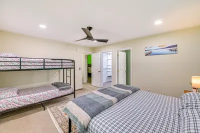 a bedroom with two bunk beds and a ceiling fan at Cozy Lake Luzerne Home - 1 Mi to Wayside Beach! in Lake Luzerne