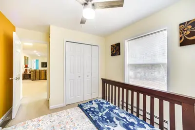 a bedroom with a bed and a ceiling fan at Cozy Lake Luzerne Home - 1 Mi to Wayside Beach! in Lake Luzerne