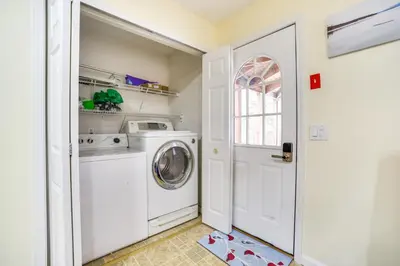 a white laundry room with a washer and dryer at Cozy Lake Luzerne Home - 1 Mi to Wayside Beach! in Lake Luzerne