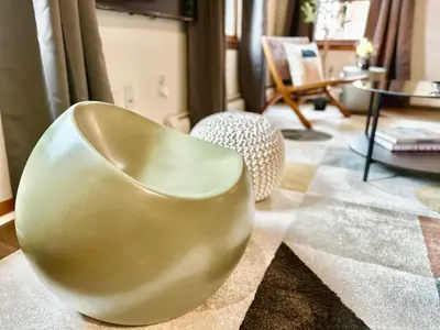 a yellow chair sitting in a living room at Downtown New Haven by Yale & Little Italy - AO Destinations in New Haven