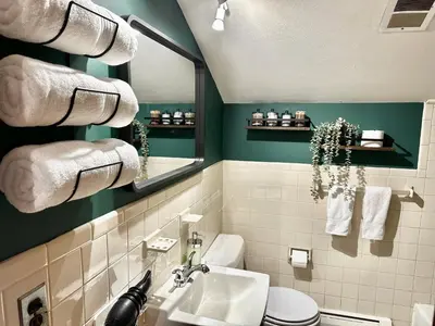 a bathroom with a sink and a toilet and towels at Downtown New Haven by Yale & Little Italy - AO Destinations in New Haven