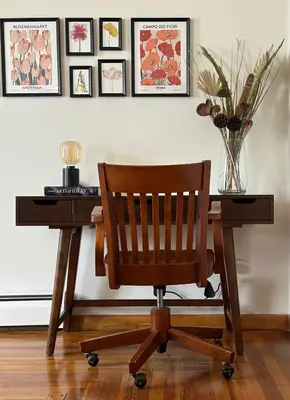 a wooden desk with a chair and a table with a vase at Downtown New Haven by Yale & Little Italy - AO Destinations in New Haven