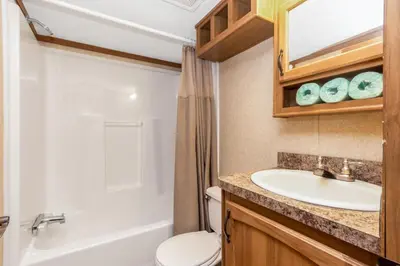 a bathroom with a sink and a toilet at Jellystone Park Birchwood Acres in Greenfield Park
