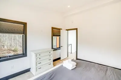 a bedroom with a bed and a dresser and a window at Custom Windham Mtn Villa with Pool, Theater and Views! in Windham