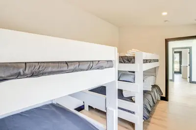 a bedroom with two bunk beds and a hallway at Custom Windham Mtn Villa with Pool, Theater and Views! in Windham