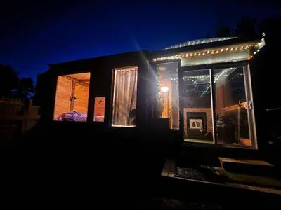 a small house with lights on it at night at The Dome house near Hunter and Hudson in Catskill