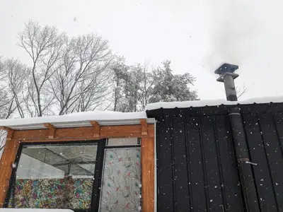 a snow covered roof with a light on top of a building at The Dome house near Hunter and Hudson in Catskill