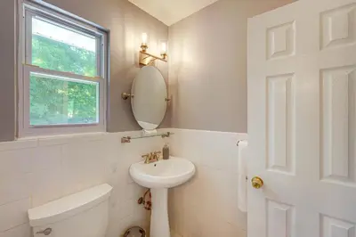 a white bathroom with a sink and a mirror at NYC-Area Escape Near River, Trails and MTA! in Ossining