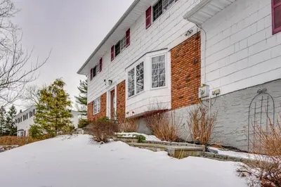 a white house with snow in front of it at NYC-Area Escape Near River, Trails and MTA! in Ossining