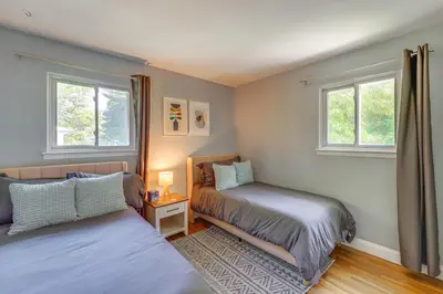 a bedroom with two beds and two windows at NYC-Area Escape Near River, Trails and MTA! in Ossining