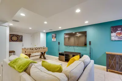 a living room with a couch and a flat screen tv at NYC-Area Escape Near River, Trails and MTA! in Ossining