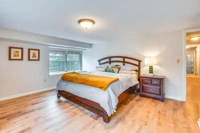 a bedroom with a bed and a wooden floor at 7 Mi to Newark Montclair Vacation Rental in Montclair
