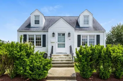 a white house with a black roof at Stay at Black Rock Harbor in Bridgeport