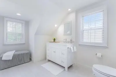 a white bathroom with a sink and a toilet at Stay at Black Rock Harbor in Bridgeport