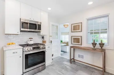 a kitchen with a stove and a microwave at Stay at Black Rock Harbor in Bridgeport