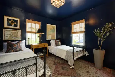 two beds in a room with blue walls and windows at Stay at Black Rock Harbor in Bridgeport