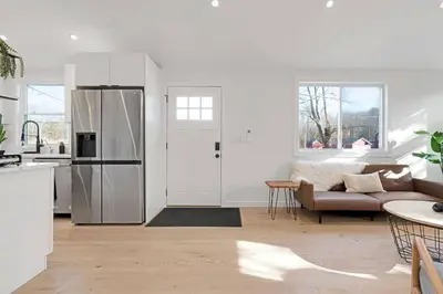 a kitchen and living room with a refrigerator and a couch at New Paltz Zen Wellness Cabin w/ Hot Tub in New Paltz