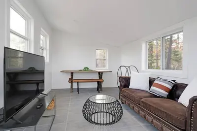 a living room with a couch and a piano at New Paltz Zen Wellness Cabin w/ Hot Tub in New Paltz