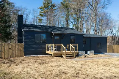 a blue tiny house with a porch and a fence at New Paltz Zen Wellness Cabin w/ Hot Tub in New Paltz