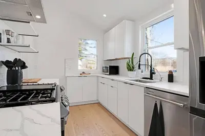 a white kitchen with a sink and a stove at New Paltz Zen Wellness Cabin w/ Hot Tub in New Paltz