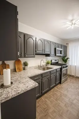 a kitchen with black cabinets and a counter top at Spacious 4BR near NYC with Parking, 10min MetLife, 20min Times Sq in North Bergen