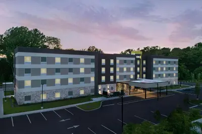 a rendering of a building with a parking lot at Home2 Suites By Hilton Poughkeepsie in Poughkeepsie