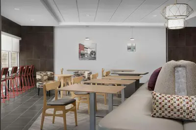 a row of tables and chairs in a restaurant at Home2 Suites By Hilton Poughkeepsie in Poughkeepsie