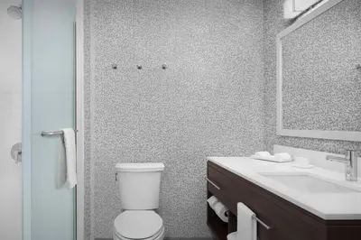 a bathroom with a toilet and a sink and a mirror at Home2 Suites By Hilton Poughkeepsie in Poughkeepsie
