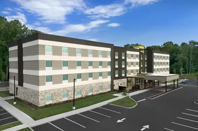a rendering of a building with a parking lot at Home2 Suites By Hilton Poughkeepsie in Poughkeepsie
