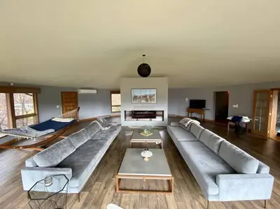 a large living room with a couch and a table at Luxury Mountain Mansion Huge Pool, Sauna, 7000sqft in Windham