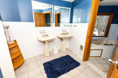 a bathroom with two sinks and a tub at Luxury Mountain Mansion Huge Pool, Sauna, 7000sqft in Windham