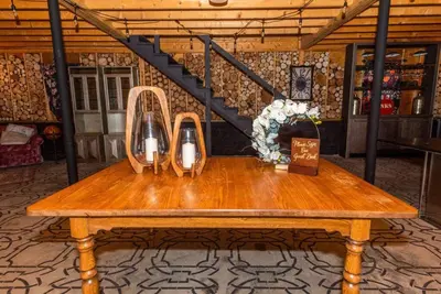 a wooden table with two candles on top of it at Luxury Mountain Mansion Huge Pool, Sauna, 7000sqft in Windham
