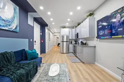a living room with a couch and a kitchen at SWJ544 - Chic 1BR in the Heart of NYC in New York