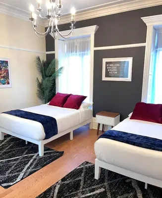 a bedroom with two beds with red pillows on them at SWJ544 - Spacious 5BR with Chef's Kitchen in New York