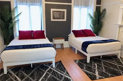 a bedroom with two beds with red pillows on them at SWJ544 - Spacious 5BR with Chef's Kitchen in New York